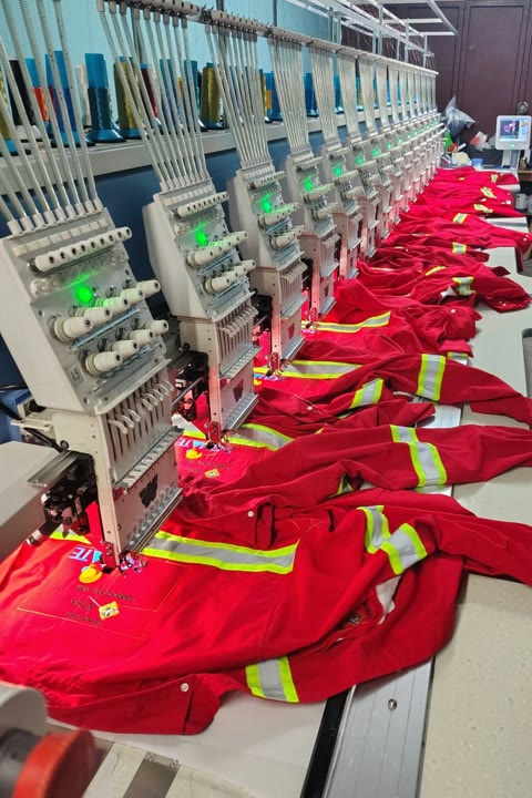 Multi-head embroidery line producing red reflective industrial uniforms at Romatextil