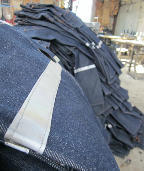 Batch of denim work pants with reflective safety detailing